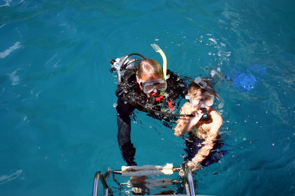 Matthew takes lessons with Dad on breathing with his regulator.